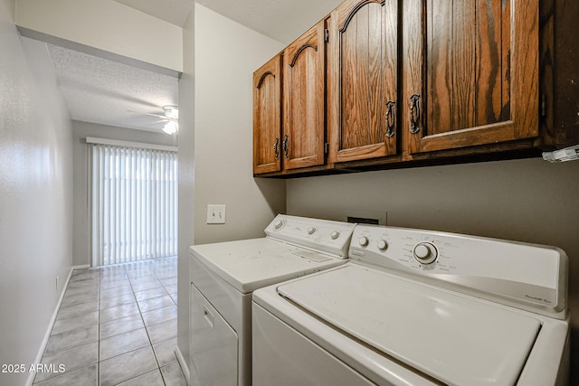 clothes washing area featuring light tile patterned floors, a textured ceiling, washing machine and dryer, and ceiling fan