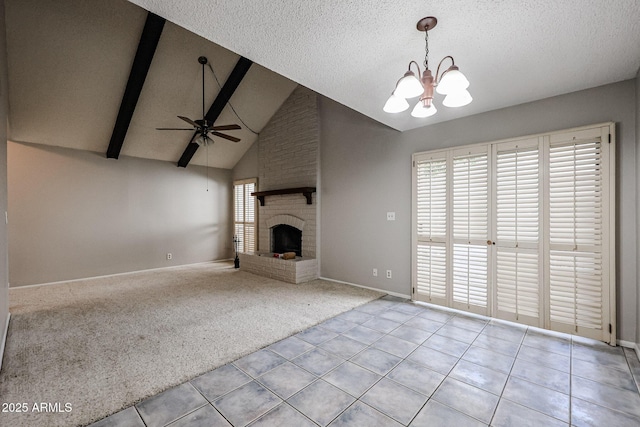 unfurnished living room featuring beam ceiling, light carpet, a brick fireplace, and a textured ceiling