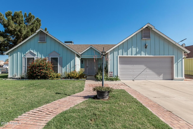 view of front of home with a garage and a front lawn