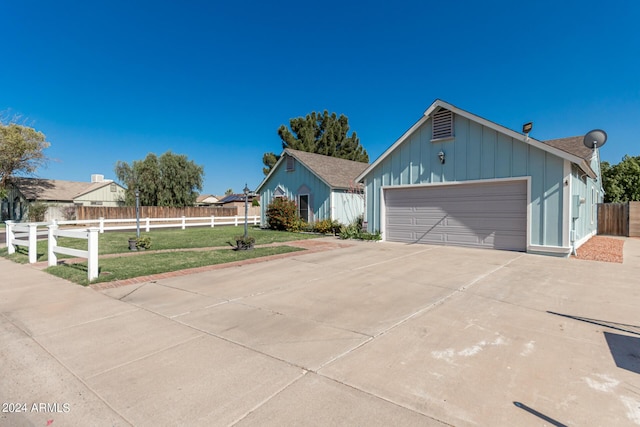 ranch-style home with a garage and a front yard