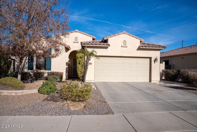 mediterranean / spanish-style home with a garage