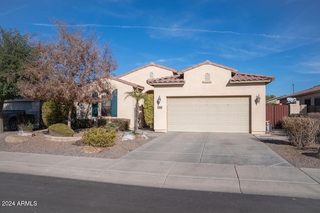 mediterranean / spanish-style home with a garage