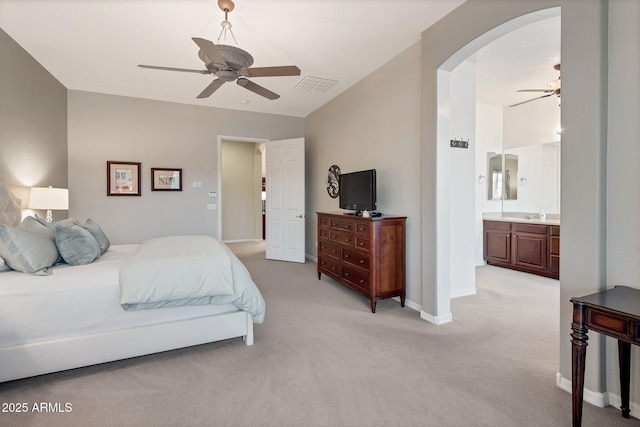 2472 E Prescott Pl, Chandler, AZ 85249 - bedroom featuring arched walkways, light carpet, baseboards, connected bathroom, and ceiling fan