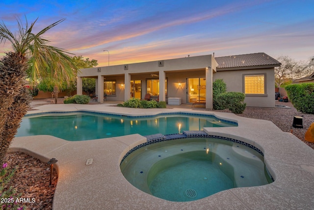 2472 E Prescott Pl, Chandler, AZ 85249 - pool at dusk featuring a patio area and a pool with connected hot tub