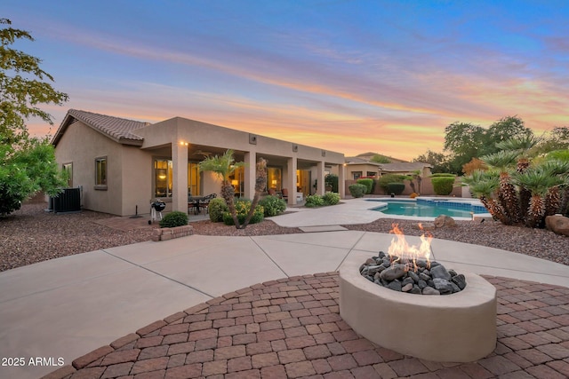 2472 E Prescott Pl, Chandler, AZ 85249 - back of property featuring a fire pit, a patio area, stucco siding, an outdoor pool, and cooling unit