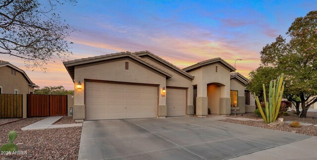 2472 E Prescott Pl, Chandler, AZ 85249 - view of front facade featuring an attached garage, stucco siding, driveway, and fence