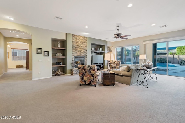 2472 E Prescott Pl, Chandler, AZ 85249 - living area with ceiling fan, carpet, built in features, a stone fireplace, and recessed lighting