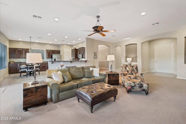 2472 E Prescott Pl, Chandler, AZ 85249 - living room featuring arched walkways, light carpet, recessed lighting, baseboards, and a ceiling fan