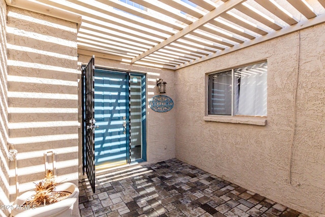 doorway to property featuring a pergola