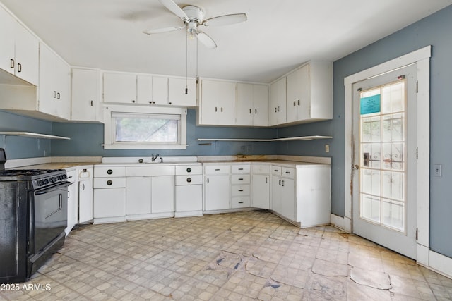 5901 E Short Ave, Globe, AZ 85501 - kitchen with black gas stove, a ceiling fan, white cabinets, and light countertops