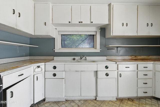 5901 E Short Ave, Globe, AZ 85501 - kitchen with open shelves, light countertops, and white cabinets