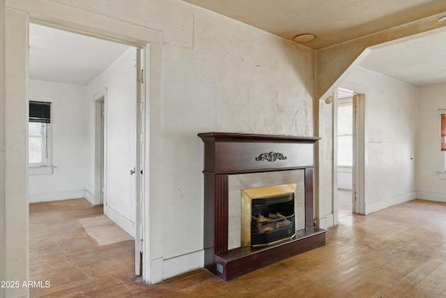 5901 E Short Ave, Globe, AZ 85501 - unfurnished living room with wood finished floors and a fireplace with raised hearth