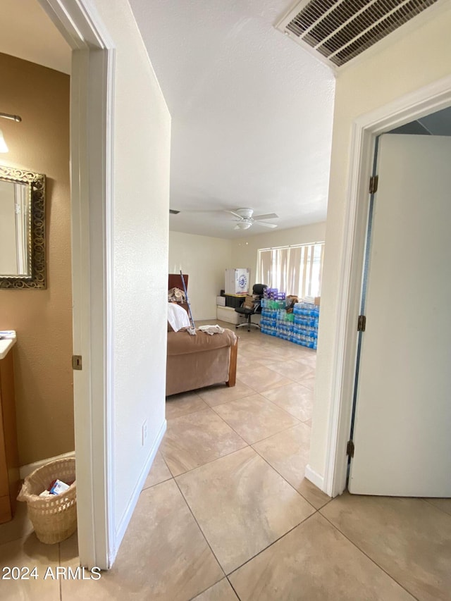 hall featuring light tile patterned flooring