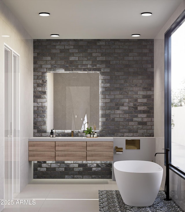 bathroom with vanity, plenty of natural light, tile patterned floors, and a bathtub