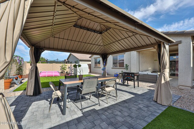 19946 W Glenrosa Ave, Litchfield Park, AZ 85340 - view of patio featuring outdoor dining area, an outdoor living space, a fenced backyard, and a gazebo