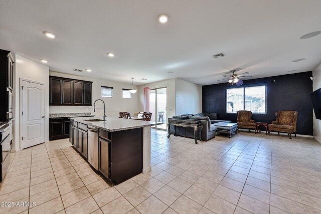 19946 W Glenrosa Ave, Litchfield Park, AZ 85340 - kitchen with light tile patterned floors, open floor plan, a healthy amount of sunlight, and a sink