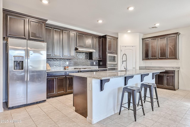 19946 W Glenrosa Ave, Litchfield Park, AZ 85340 - kitchen featuring stainless steel appliances, visible vents, a sink, and dark brown cabinets