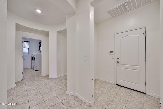 19946 W Glenrosa Ave, Litchfield Park, AZ 85340 - entryway with light tile patterned floors, baseboards, visible vents, and washer and clothes dryer