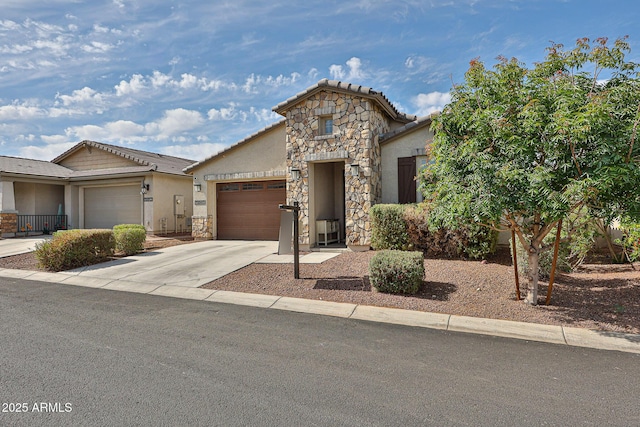 19946 W Glenrosa Ave, Litchfield Park, AZ 85340 - view of front of house with stone siding, stucco siding, a tiled roof, concrete driveway, and an attached garage