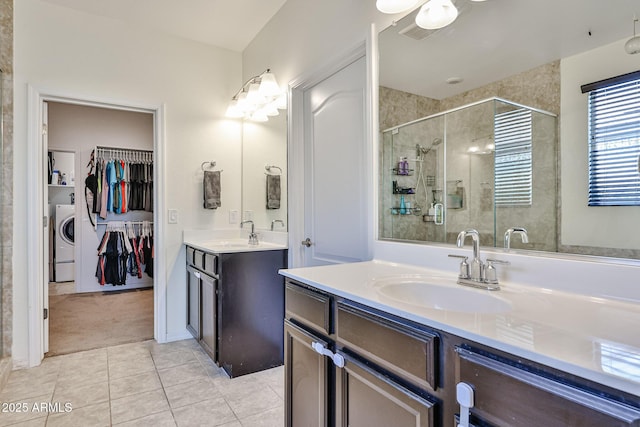 19946 W Glenrosa Ave, Litchfield Park, AZ 85340 - full bathroom featuring tile patterned flooring, washer / clothes dryer, two vanities, a shower stall, and a sink