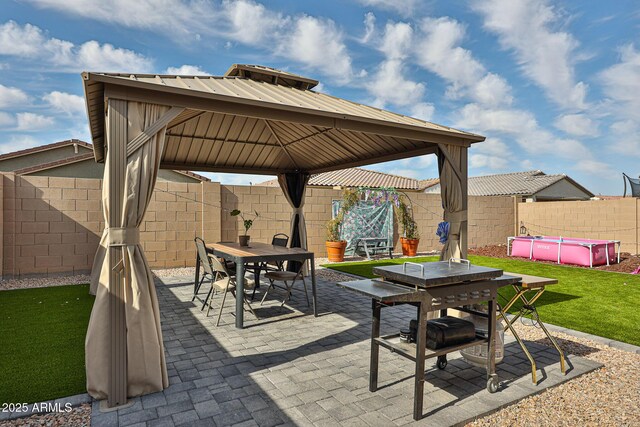 19946 W Glenrosa Ave, Litchfield Park, AZ 85340 - view of patio / terrace with outdoor dining area, a fenced backyard, a fenced in pool, and a gazebo