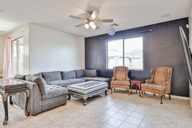 19946 W Glenrosa Ave, Litchfield Park, AZ 85340 - living area with light tile patterned flooring, ceiling fan, visible vents, and a healthy amount of sunlight