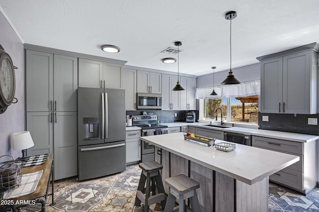 2921 N 103rd Ave, Avondale, AZ 85392 - kitchen featuring appliances with stainless steel finishes, light countertops, and gray cabinetry