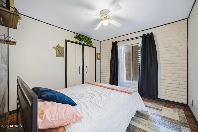 2921 N 103rd Ave, Avondale, AZ 85392 - bedroom with brick wall, wood finished floors, a ceiling fan, and a closet