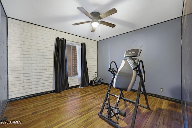 2921 N 103rd Ave, Avondale, AZ 85392 - workout room with ceiling fan, brick wall, and wood finished floors