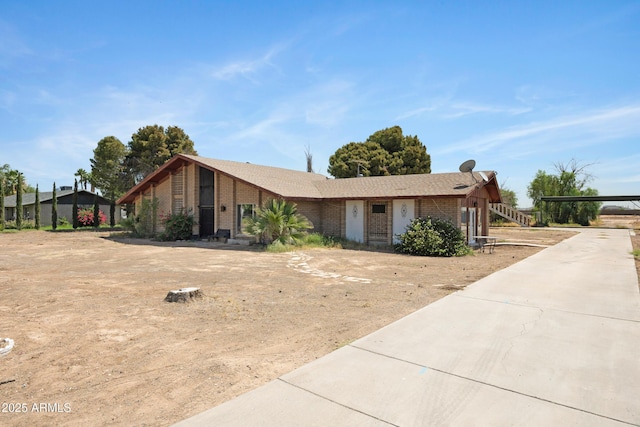 2921 N 103rd Ave, Avondale, AZ 85392 - view of front of home featuring brick siding, a carport, and driveway