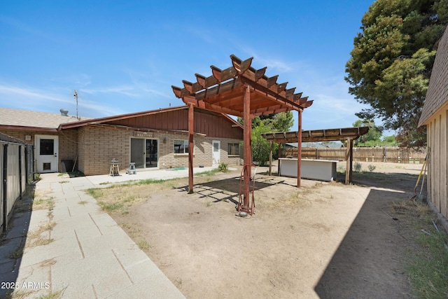 2921 N 103rd Ave, Avondale, AZ 85392 - back of house featuring brick siding, a patio, a fenced backyard, a pergola, and a hot tub
