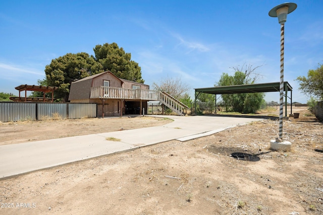 2921 N 103rd Ave, Avondale, AZ 85392 - view of property exterior with stairs, a deck, concrete driveway, and a detached carport