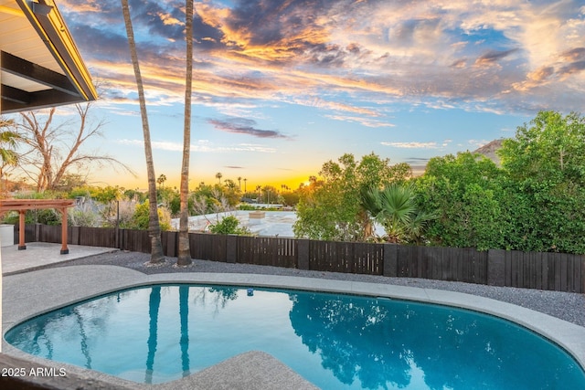 908 W Pershing Ave, Phoenix, AZ 85029 - pool at dusk with a fenced backyard and a patio