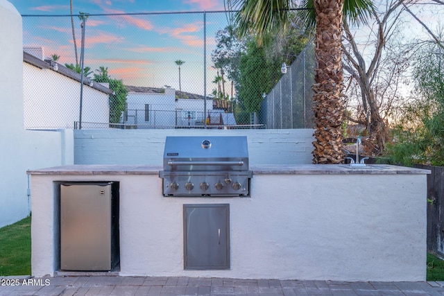 908 W Pershing Ave, Phoenix, AZ 85029 - patio terrace at dusk featuring area for grilling
