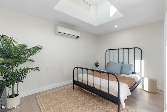 908 W Pershing Ave, Phoenix, AZ 85029 - bedroom featuring a wall unit AC, a skylight, light wood-style floors, and recessed lighting