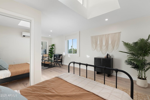 908 W Pershing Ave, Phoenix, AZ 85029 - bedroom with wood finished floors, an AC wall unit, recessed lighting, and a skylight