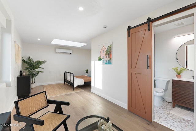 908 W Pershing Ave, Phoenix, AZ 85029 - workout room with an AC wall unit, a barn door, light wood finished floors, recessed lighting, and a skylight