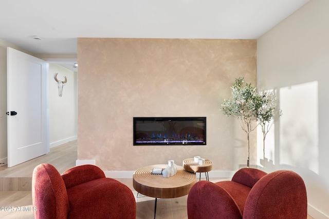908 W Pershing Ave, Phoenix, AZ 85029 - living room featuring light wood-type flooring and a glass covered fireplace