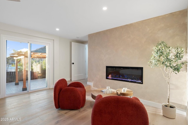 908 W Pershing Ave, Phoenix, AZ 85029 - living room with light wood-type flooring, a glass covered fireplace, and recessed lighting