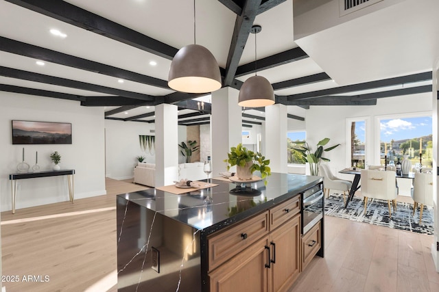 908 W Pershing Ave, Phoenix, AZ 85029 - kitchen featuring beamed ceiling, recessed lighting, light wood-type flooring, open floor plan, and brown cabinets