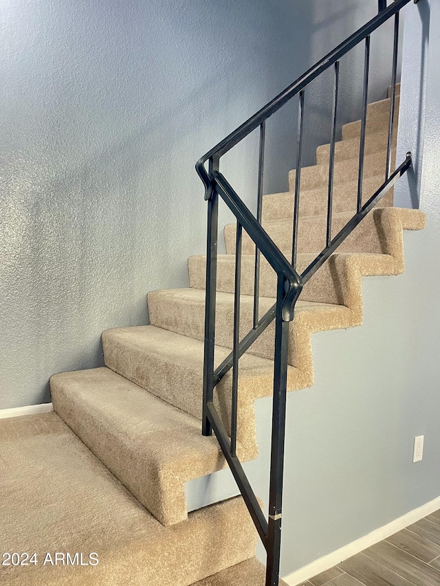 stairs with hardwood / wood-style floors