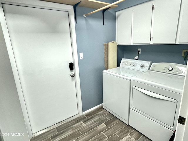 clothes washing area with cabinets and separate washer and dryer