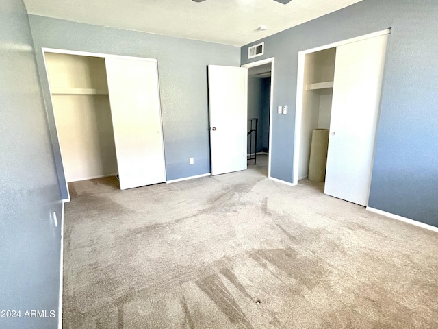 unfurnished bedroom featuring ceiling fan and carpet floors