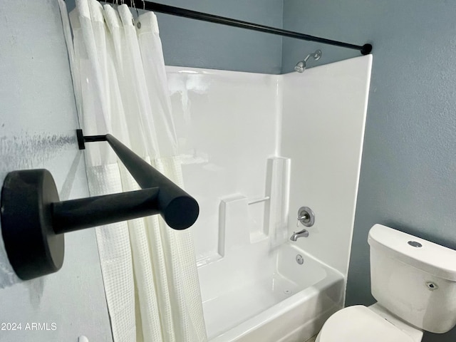 bathroom with shower / bath combo and toilet