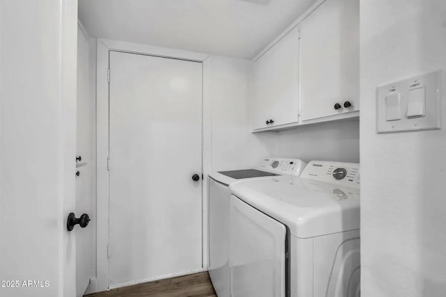 laundry room with separate washer and dryer, dark hardwood / wood-style floors, and cabinets