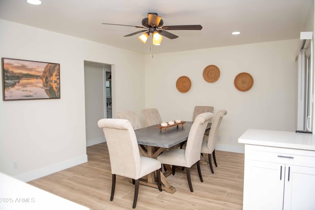 dining room featuring ceiling fan and light hardwood / wood-style flooring