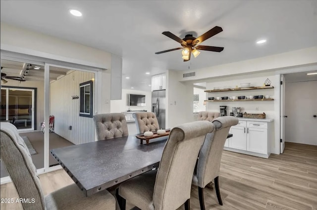 dining room featuring light hardwood / wood-style flooring and ceiling fan