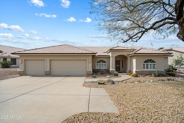 15225 E Golden Eagle Blvd, Fountain Hills, AZ 85268 - mediterranean / spanish house with stucco siding, an attached garage, a tiled roof, and concrete driveway