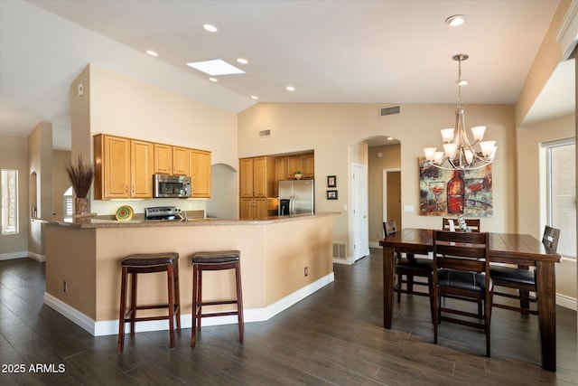 15225 E Golden Eagle Blvd, Fountain Hills, AZ 85268 - kitchen featuring arched walkways, visible vents, stainless steel appliances, and dark wood-type flooring