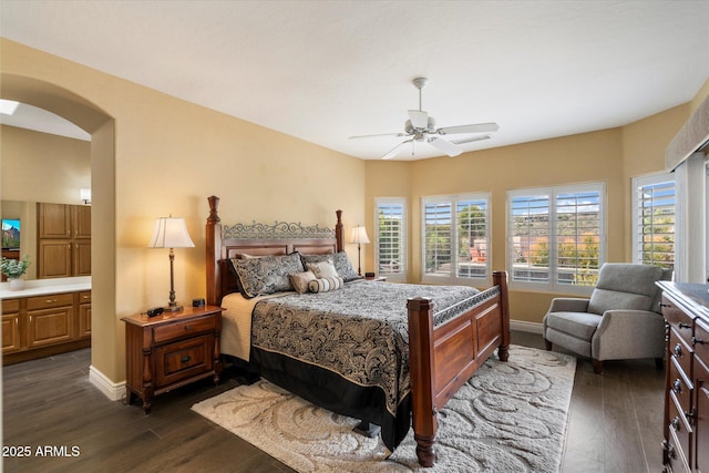 15225 E Golden Eagle Blvd, Fountain Hills, AZ 85268 - bedroom with a ceiling fan, arched walkways, dark wood-style floors, and baseboards